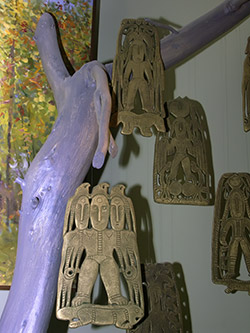 Фигурки с археологических раскопок на ветке дерева.
